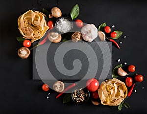 Fettuccine tagliatelle paste and slate board with mushrooms, her