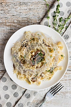 Fetuchini alfredo with mushrooms and chicken ham in creamy cheese sauce