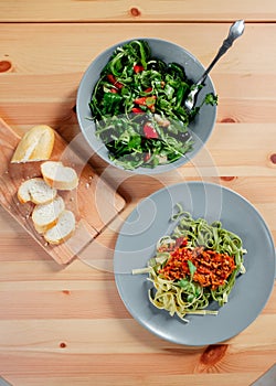 Fetuchini pasta with beef tomato sauce on wood table , italian food