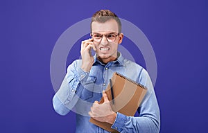 Fevered wound guy talking on mobile phone with gritted teeth from anger