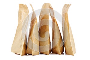 Few brown paper packets on a white