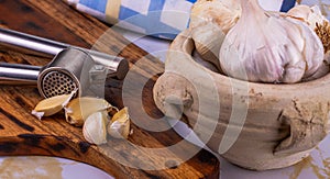 A few bulbs of garlic in a clay pot.