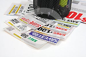 A few of coupons on the desk with pen holder