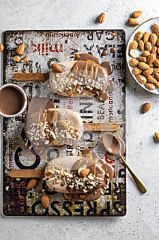 A few delicious homemade vegan ice cream bars or popsicles covered with chocolate and nuts top view, flat lay