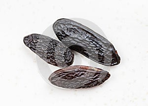 Few dried tonka beans close up on gray