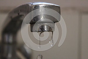 A few drops falling from a tap