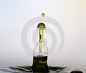 A few drops of water splash together, like a bottle.