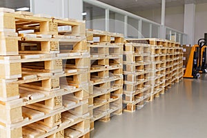 Few empty wooden pallets for storage in an empty warehouse.