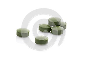 Few green pills isolaed on white background.