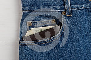 A few hundred dollars banknotes in a jeans pocket in your wallet. The concept of wealth and salary for work