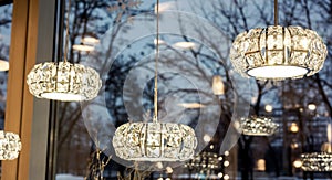 Few luxury crystal round chandeliers in light shop