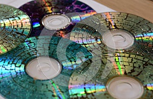 Few microwaved CDs on white background