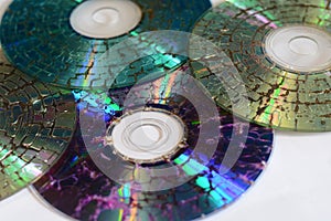 Few microwaved CDs on white background
