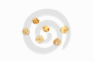 A few pieces caramel popcorn on white background.