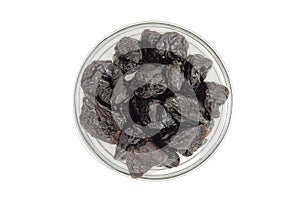 A few prunes in a glass cup