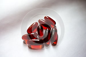 Few red capsules of krill oil