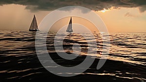A few sailboats in a sea at sunset, magic sun reflection, sun path, the sky of pink color, the darkness storm sky, rain