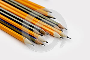 few sharply sharpened pencils of different color on the white table