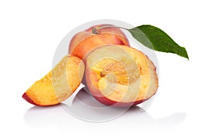 Few sliced nectarines with leaf isolated on white photo