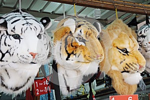 A few sling haversack bags with tigers and lion head designs on display for sale