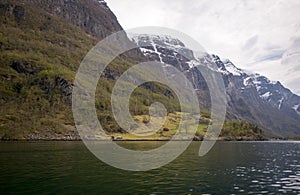 few small rural houses in aurlandsfjord in early summer