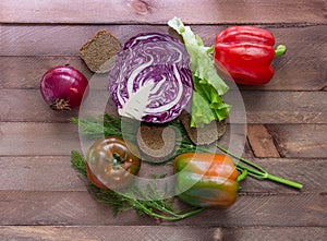 Few vegetables in the center of the wooden table