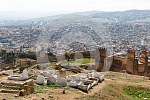 Fez, Morocco aerial view. The ancient city wall is in the foreground and behind it, an overview of the old neighborhood.