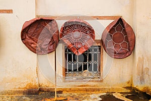 Fez, Morocco - three unstuffed leather ottomans hang on a wall to dry.