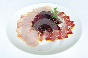 Fferent varieties of meat sliced on a plate