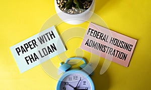 FHA credit paper on yellow background with clock and cactus