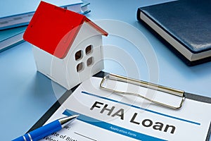FHA loan application and model of home.