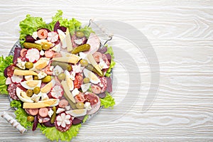 Fiambre, salad of Guatemala, Mexico and Latin America, on large plate top view white wooden background top view photo