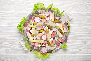 Fiambre, salad of Guatemala, Mexico and Latin America, on large plate top view white wooden background top view photo