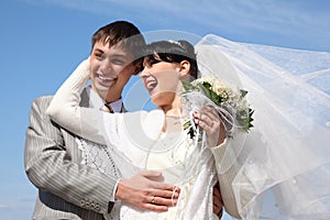 Fiance with bride against background of sky