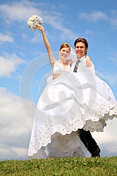 Fiance holds bride on the hand