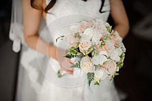 Fiancee in a beautiful white dress holding a bouquet