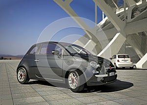 Fiat 500 city car, outside of modern industrial building environment.