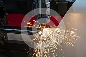 The fiber laser cutting machine cutting the stainless steel tube control by CNC program.