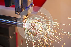 The fiber laser cutting machine cutting the stainless steel tube control by CNC program.