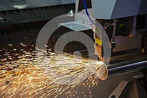 The fiber laser cutting machine cutting the stainless steel tube control by CNC program.