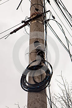 A fiber optic cable harness for communication weighs on a concrete column. Telecommunications and Internet