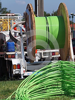 fiber optic cable piled up behind an installation truck