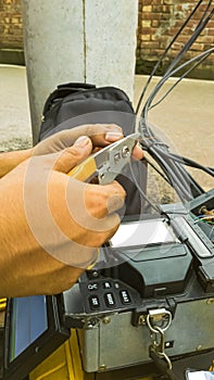 Fiber Optic Cable Splicing Technician Using Modern Fusion Splicer Tool