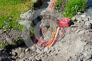 fiber optic cables been installed underground in dug trenches front of residential homes.