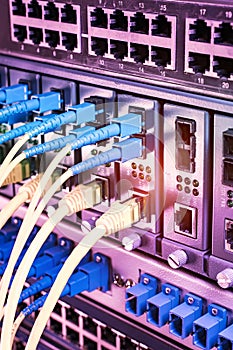 Fiber Optic cables connected to an optic ports and Network cables connected to ethernet ports