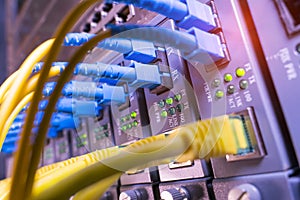 Fiber Optic cables connected to optic ports and Network cables connected to ethernet ports