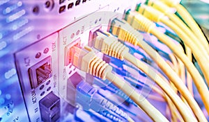 Fiber Optic cables connected to an optic ports and Network cables connected to ethernet ports