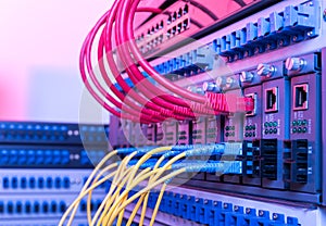 Fiber Optic cables and UTP Network cables connected hub ports.