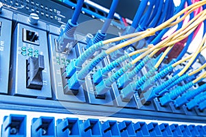 Fiber Optic cables and UTP Network cables connected hub ports.