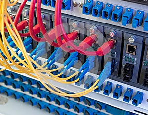 Fiber Optic cables and UTP Network cables connected hub ports.